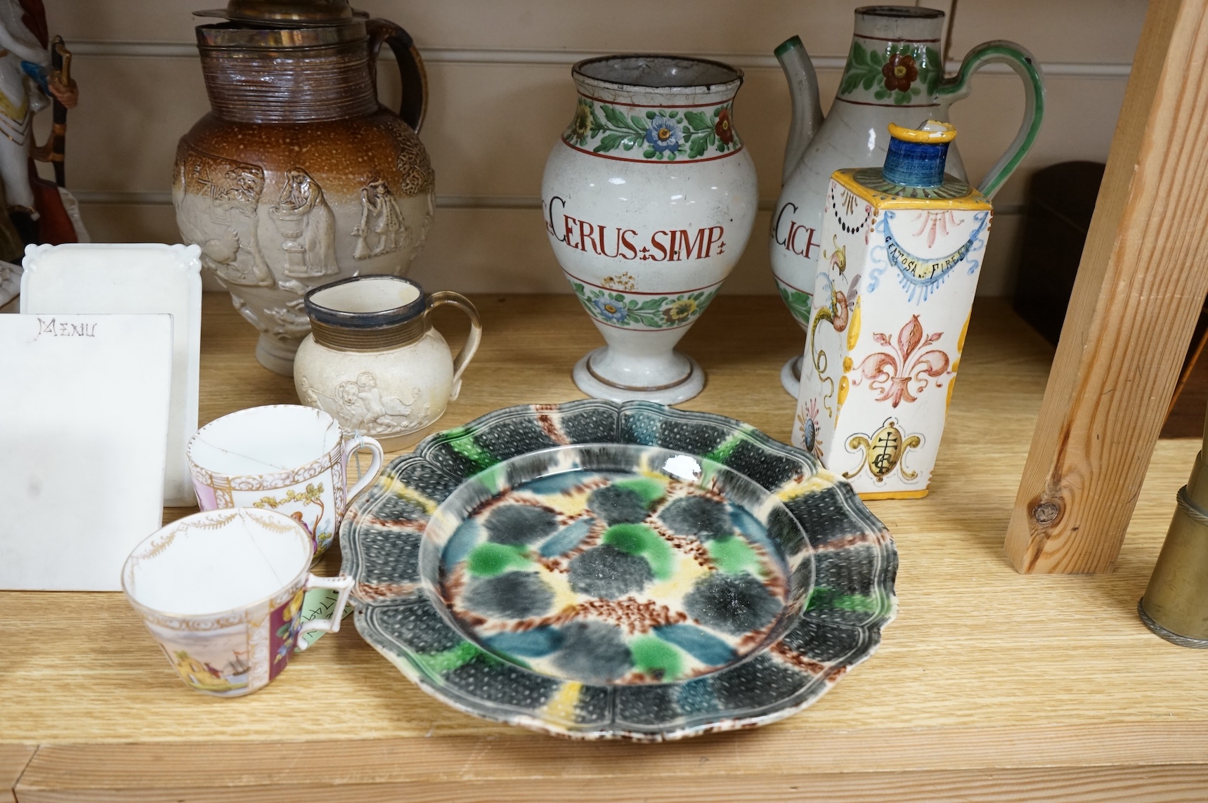 A group of Continental ceramics including two late 18th/early 19th century Italian maiolica wet drug jars, a Staffordshire Whieldon type tortoiseshell glazed plate c.1770 and a silver mounted Mortlake stoneware jug, 24cm